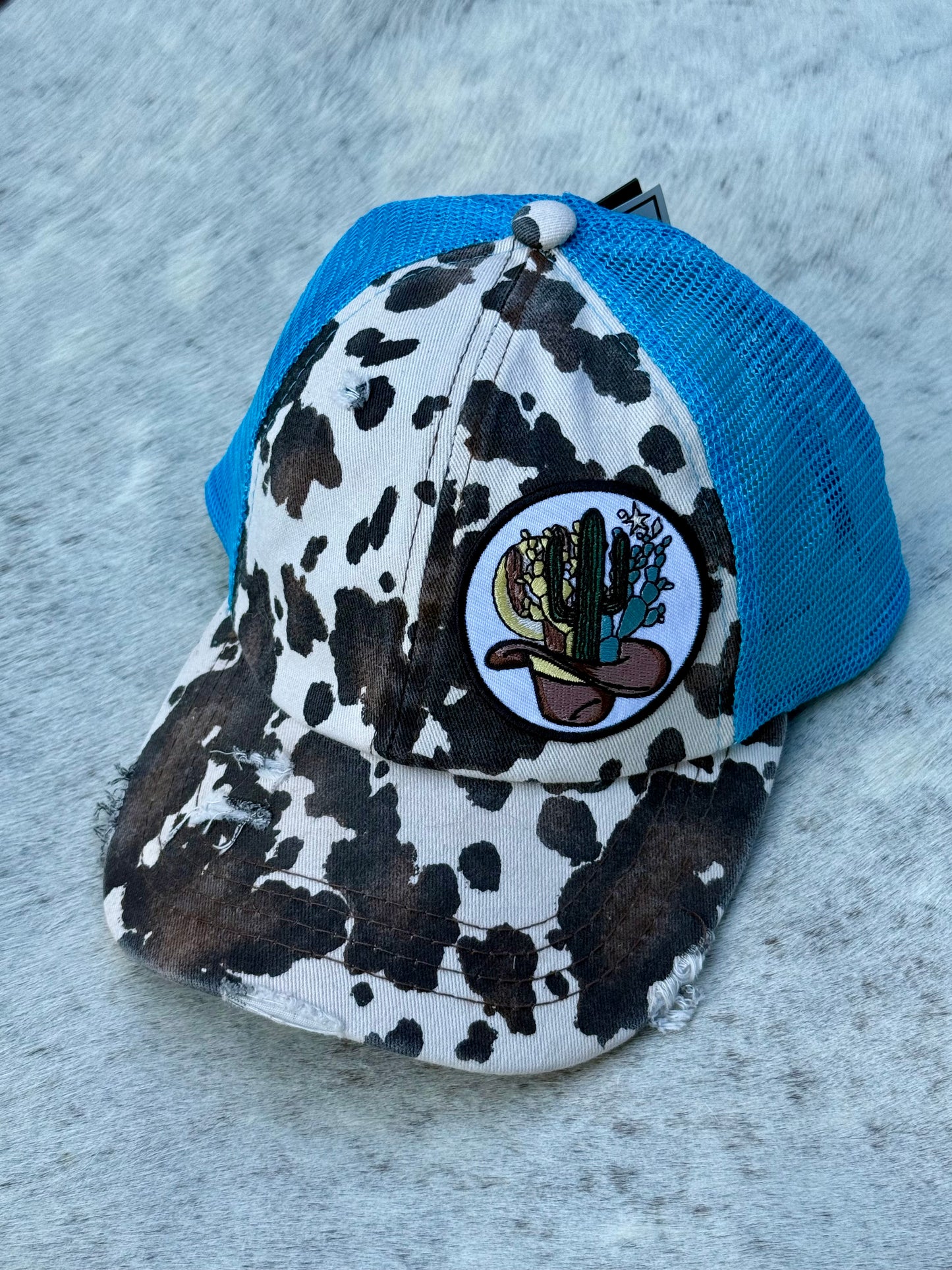 CC Cow Print Distressed Trucker Hat with Cactus Patch